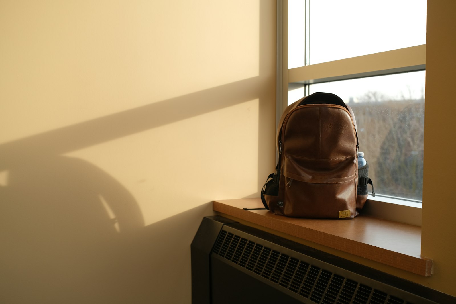 Child poverty in the UK: a worn school backpack resting on a sunlit windowsill